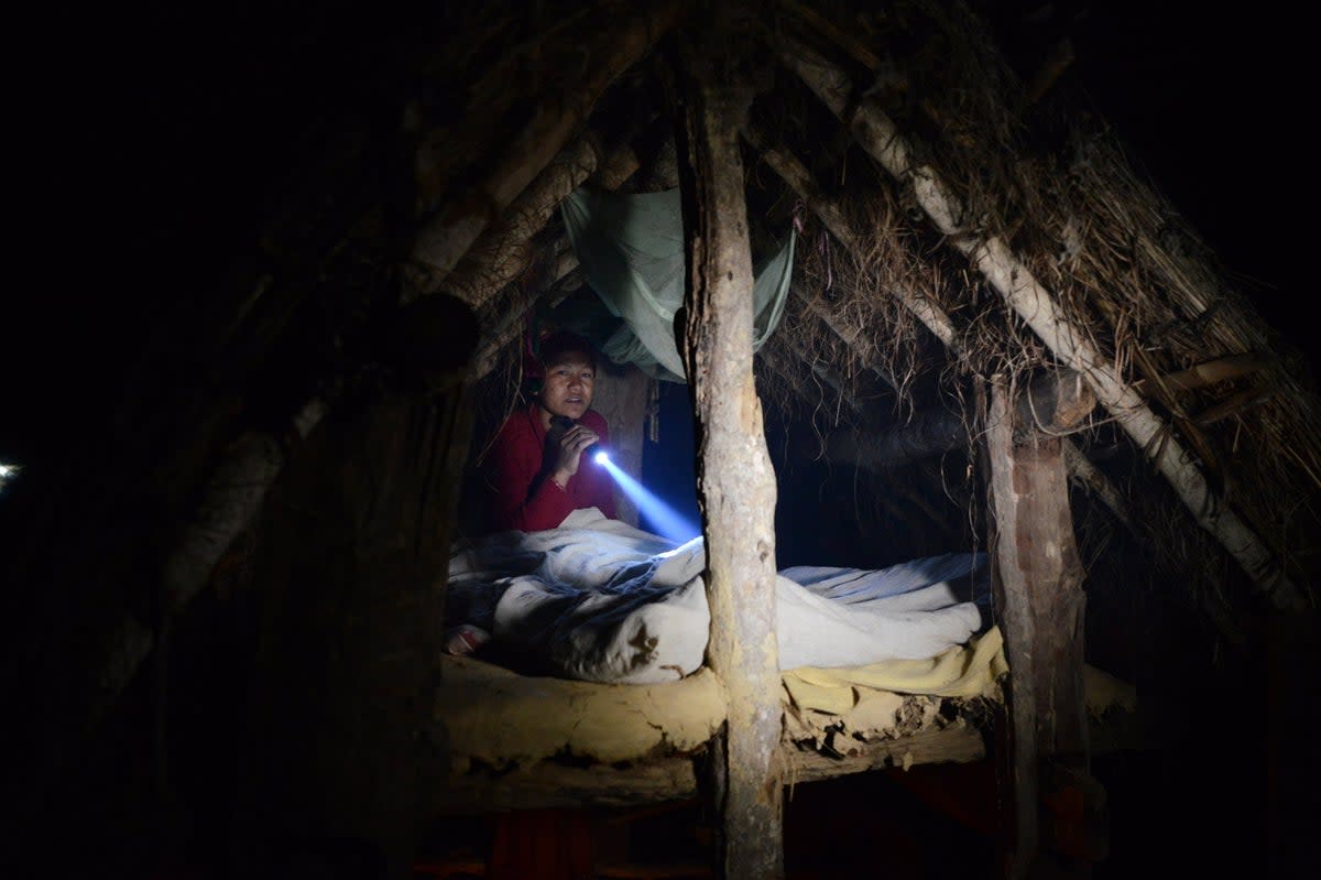 Nepalese woman Pabitra Giri prepares to sleep in a Chhaupadi hut during her menstruation period in the Surkhet District in 2017 (AFP via Getty Images)