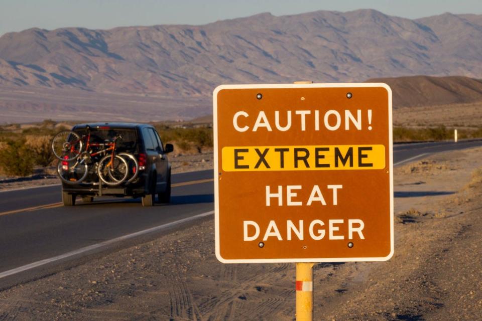 Signage warns visitors of extreme heat danger on July 15, 2023 near Furnace Creek in Death Valley National Park.