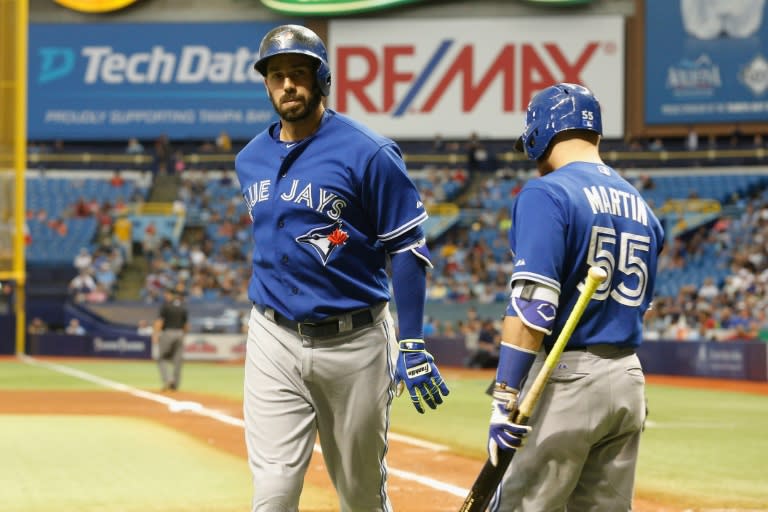 Chris Colabello (L) of the Toronto Blue Jays celebrates his home run with teammate Russell Martin during the fourth inning of their game against the Tampa Bay Rays, at Tropicana Field in St. Petersburg, Florida, on October 4, 2015