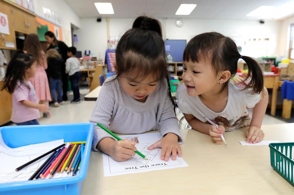 Ava Hergn, left, and Feyre Lee participate in a table time fine motor activity during their 4K class at Foster Elementary School Tuesday, May 2, 2023, in Appleton, Wis.