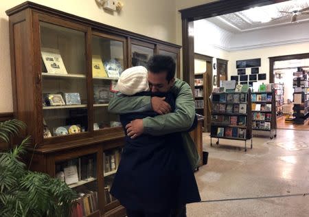 An Iranian man, a student in the United States, embraces his mother as they say goodbye at the Haskell Free Library and Opera House, which straddles the U.S.-Canada border in Stanstead, Quebec and in Derby Line, Vermont, U.S., November 3, 2018. Picture taken November 3, 2018. REUTERS/Yeganeh Torbati