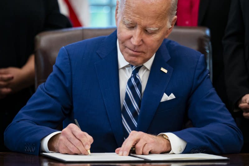 In the Oval Office on Monday, U.S. President Joe Biden signs a presidential memorandum establishing the White House Initiative on Women's Health Research. Photo by Al Drago/UPI