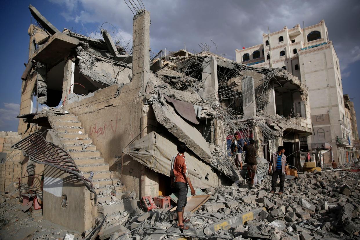 Men inspect a house destroyed by a Saudi-led airstrike in Sanaa, Yemen: AP