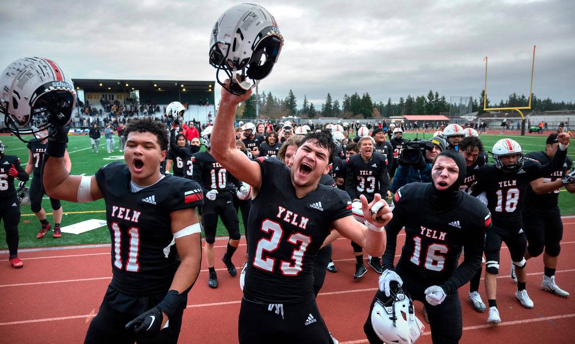 Yelm’s Isaiah Patterson (from left), Brayden Platt and Nathan Ford lead the Tornados in a post-game cheer to thank their fans following their 28-27 victory over the Bellevue Wolverines in Saturday afternoon’s 3A football state semifinal game at Art Crate Field in Spanaway, Washington, on Nov. 26, 2022.