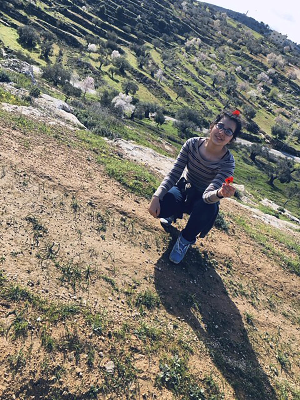 In this March 12, 2020 photo provided by Reem Mousa, Anisa Mousa of Selbyville, Delaware, poses for a photograph while sightseeing with her father, Ismail, near the Palestinian village of Qaryout. Mousa and his daughter found themselves stranded and separated from each other after their travels plans and efforts to return home were thwarted because of the coronavirus pandemic. (Reem Mousa via AP)