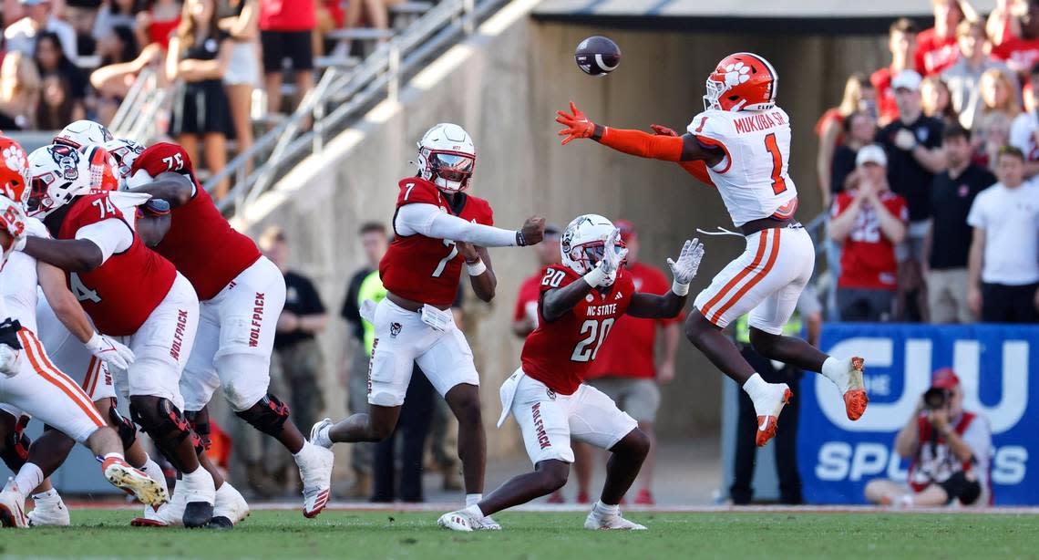 N.C. State quarterback MJ Morris (7) passes past Clemson safety Andrew Mukuba (1) during the second half of N.C. State’s 24-17 victory over Clemson at Carter-Finley Stadium in Raleigh, N.C., Saturday, Oct. 28, 2023. Ethan Hyman/ehyman@newsobserver.com