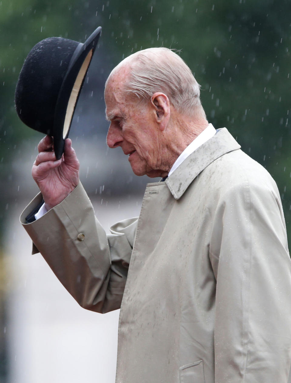 Britain's Prince Philip, Duke of Edinburgh, in his role as Captain General, Royal Marines, attends a Parade to mark the finale of the 1664 Global Challenge on the Buckingham Palace Forecourt in central London on August 2, 2017.   Prince Philip, the 96-year-old husband of Queen Elizabeth II, conducted his final solo public engagement on August 2, 2017, overseeing a military parade in the pouring rain before retiring from a lifetime of service. The Duke of Edinburgh, wearing a raincoat and bowler hat, met members of the Royal Marines and veterans -- many younger than him -- before taking the salute in the forecourt of Buckingham Palace.   / AFP PHOTO / POOL / Yui Mok        (Photo credit should read YUI MOK/AFP via Getty Images)