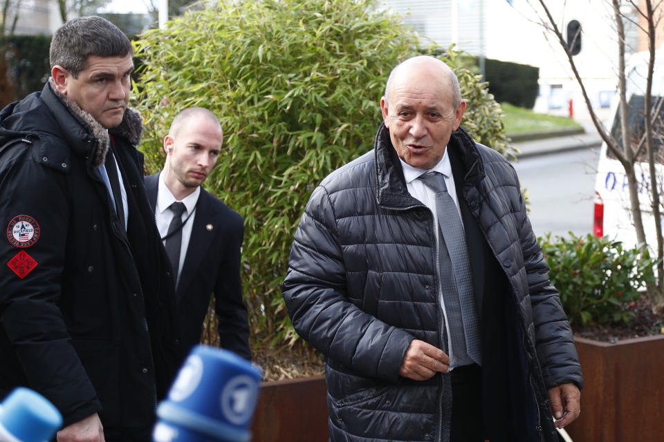 French Foreign Minister Jean-Yves Le Drian, right, speaks with the media as he arrives to meet with German Foreign Minister Heiko Maas, British Foreign Secretary Dominic Raab, Italian Foreign Minister Luigi Di Maio and European Union foreign policy chief Josep Borrell to discuss the situation in Libya at the EEAS building in Brussels, Tuesday, Jan. 7, 2020. The ministers will also hold talks later Tuesday which are expected to center on the situation in Iran and Iraq. (Francois Lenoir, Pool Photo via AP)