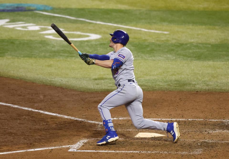 New York Mets designated hitter Mark Canha hits an RBI triple in the ninth inning against the Arizona Diamondbacks at  Chase Field in Phoenix on July 5, 2023.