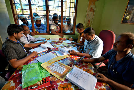 People wait to check their names on the draft list at the National Register of Citizens (NRC) centre at a village in Nagaon district, Assam state, India, July 30, 2018. REUTERS/Stringer