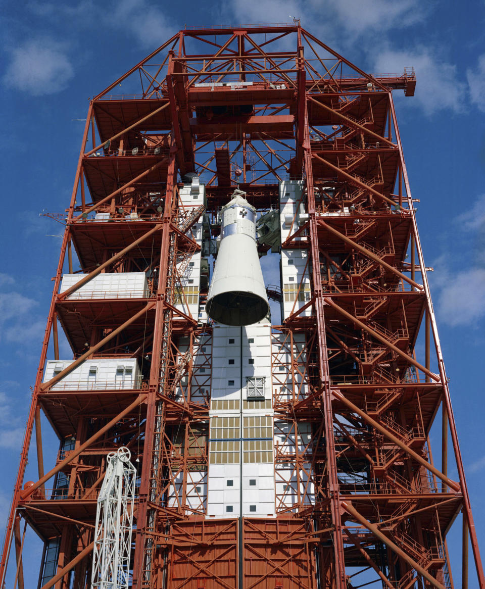 In this 1967 photo made available by NASA, the Apollo spacecraft is hoisted to the top of the gantry at Pad 34 at Cape Kennedy, Fla., for the Apollo/Saturn 204 mission. During a launch pad test on Jan. 27, 1967, a flash fire erupted inside the capsule killing the three Apollo crew members. (NASA via AP)