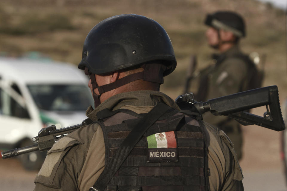 Chihuahua state police officers man a checkpoint in Janos, Chihuahua state, northern Mexico, Tuesday, Nov. 5, 2019. Drug cartel gunmen ambushed three SUVs along a dirt road, slaughtering six children and three women, all U.S. citizens living in northern Mexico, in a grisly attack that left one vehicle a burned-out, bullet-riddled hulk, authorities said Tuesday. (AP Photo/Christian Chavez)