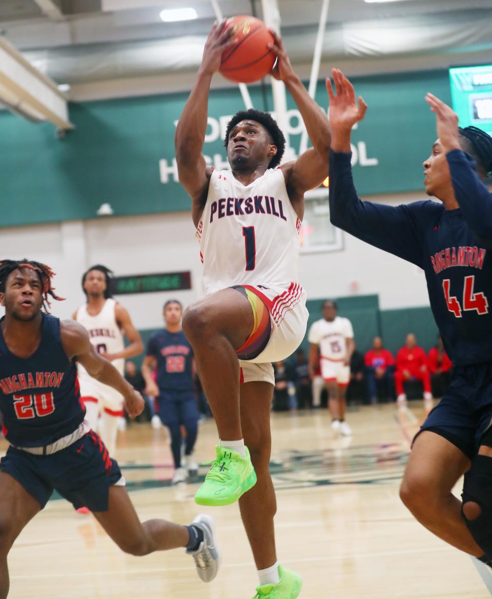 Peekskill's Amir Thames (1) drives to the basket against Binghamton during the state Class AA subregional playoff game at Yorktown High School March 6, 2024. Peekskill won the game 53-52.