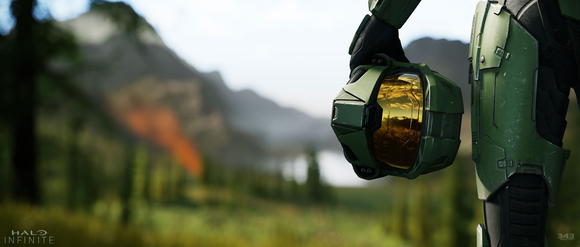 Master Chief from Microsoft's Halo series holding his helmet and looking at a mountain landscape.