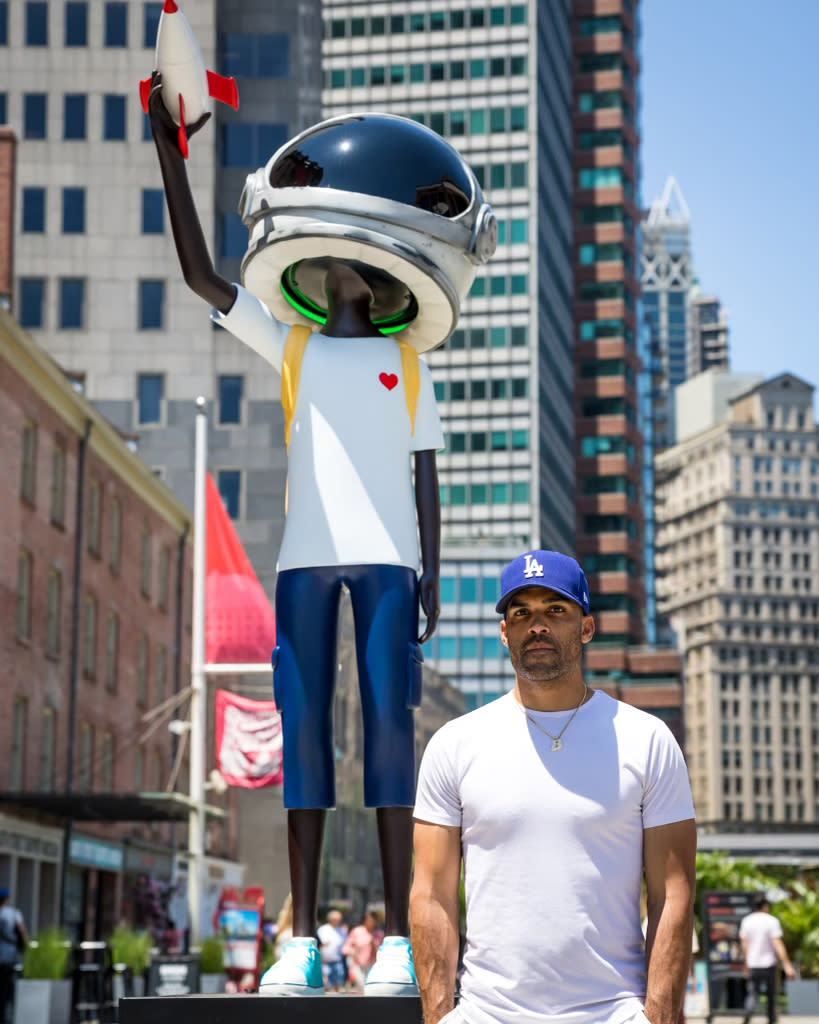 Artist Micah Johnson with a statue of Aku in New York City<span class="copyright">Courtesy of Micah Johnson</span>