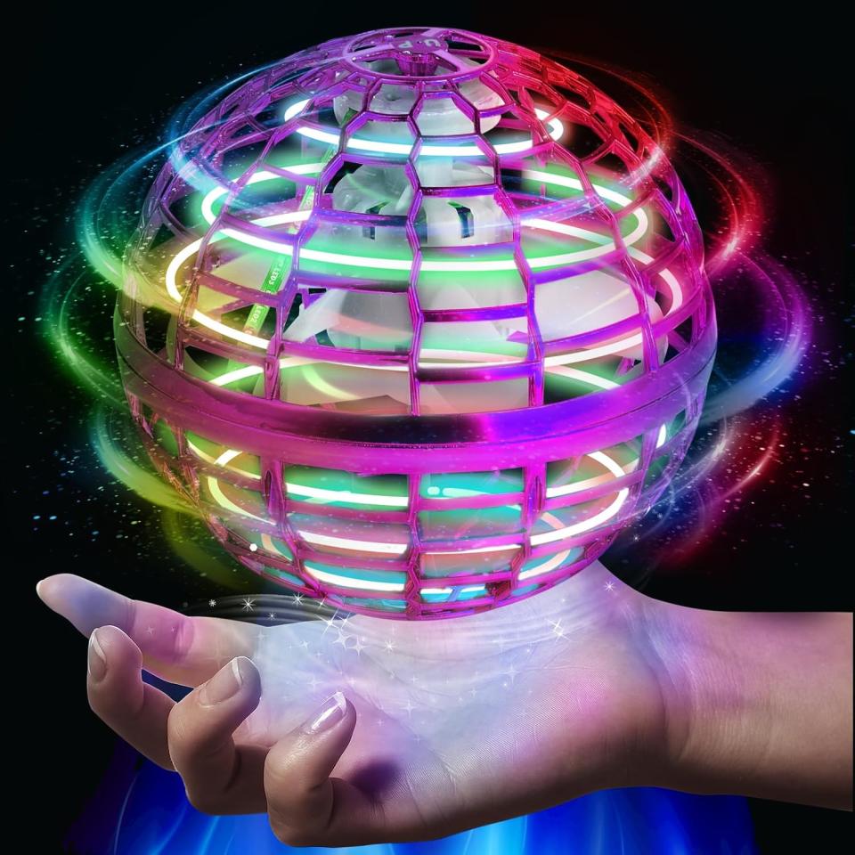 model holding plastic orb ball toy glowing