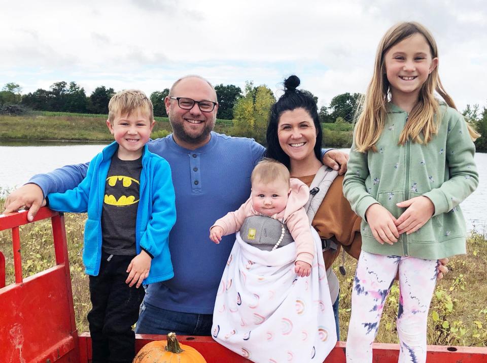 Karl Witt, the Fowlerville Christmas in the 'Ville grand marshal, second from left, is shown Monday, Oct. 31, 2022, with his son Hudson, 5, daughter Morgan, 10 months, wife Megan and daughter Lyndsey, 9.