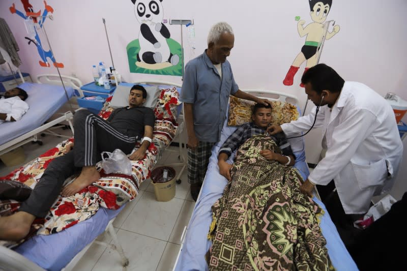 People recuperate from dengue fever at a hospital in Hodeidah