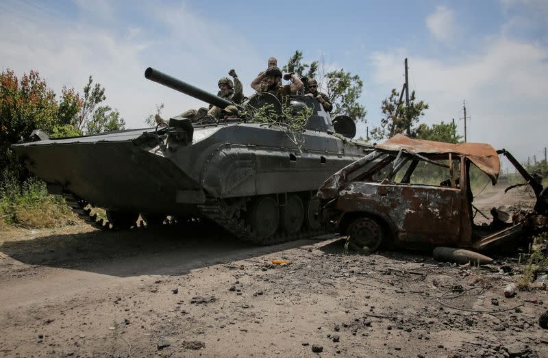 FILE PHOTO: Ukrainian service members ride a BMP-1 infantry fighting vehicle near the front line in the newly liberated village Neskuchne