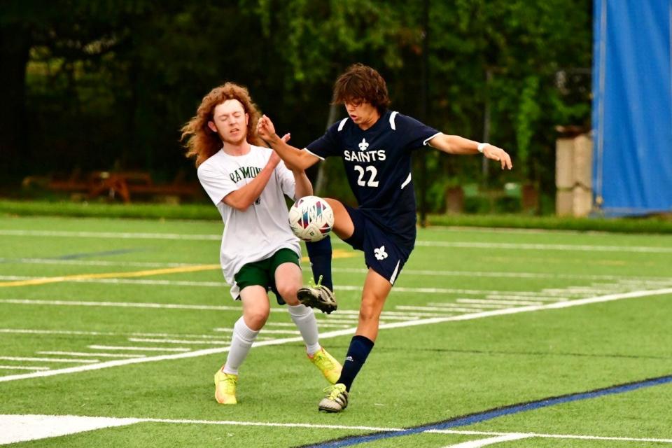 St. Thomas Aquinas midfielder Ethan Levine, right, battles for possession with a Raymond defender in Tuesday's Division III boys soccer match. St. Thomas improved to 2-0 with a 3-1 win.