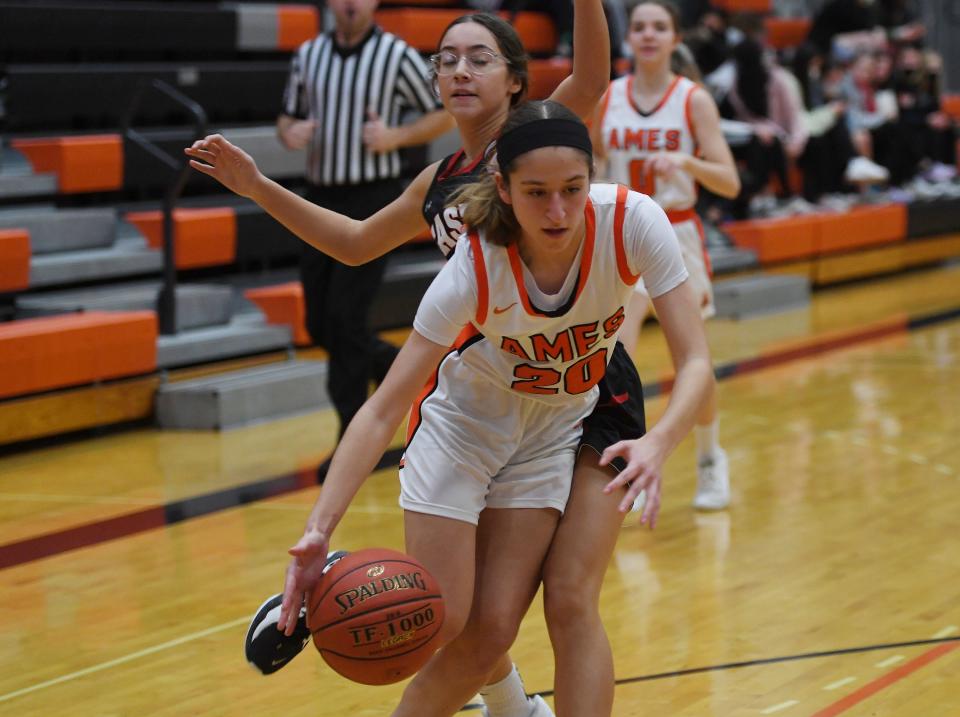Ames' Emma Evans drives past Des Moines East's Karina Chavez during the second quarter of the Little Cyclones' 62-16 victory over the Scarletts Tuesday at the Ames High Gym in Ames.
