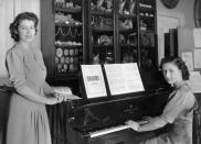 <p>Once again in the palace's study room, Princesses Elizabeth and Margaret show off their musical talents.</p>