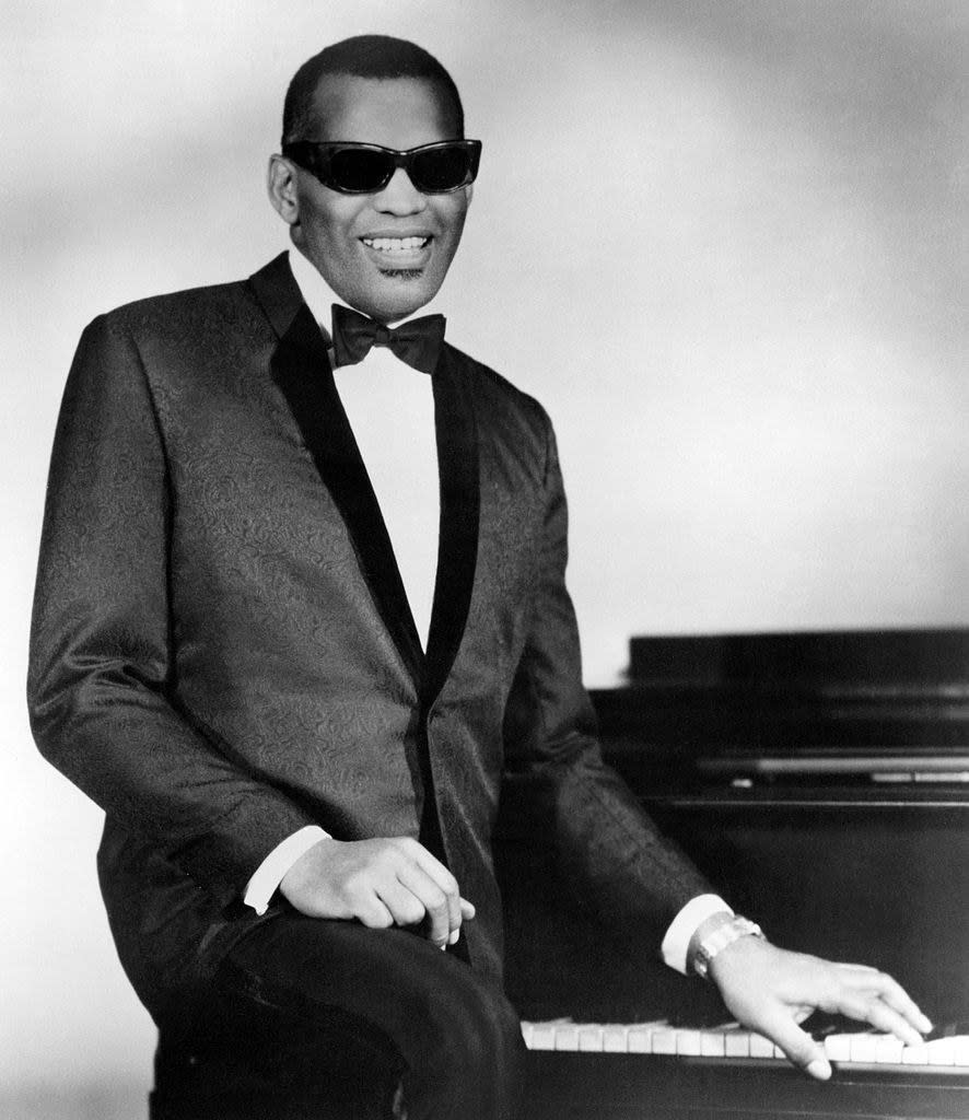 Charles posing for a portrait by his piano, late '50s/early '60s