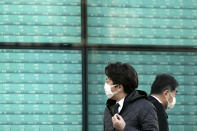 People walk past an electronic stock board showing Japan's Nikkei 225 index at a securities firm in Tokyo Friday, Feb. 28, 2020. Asian stock markets have fallen further on virus fears after Wall Street endured its biggest one-day drop in nine years. (AP Photo/Eugene Hoshiko)