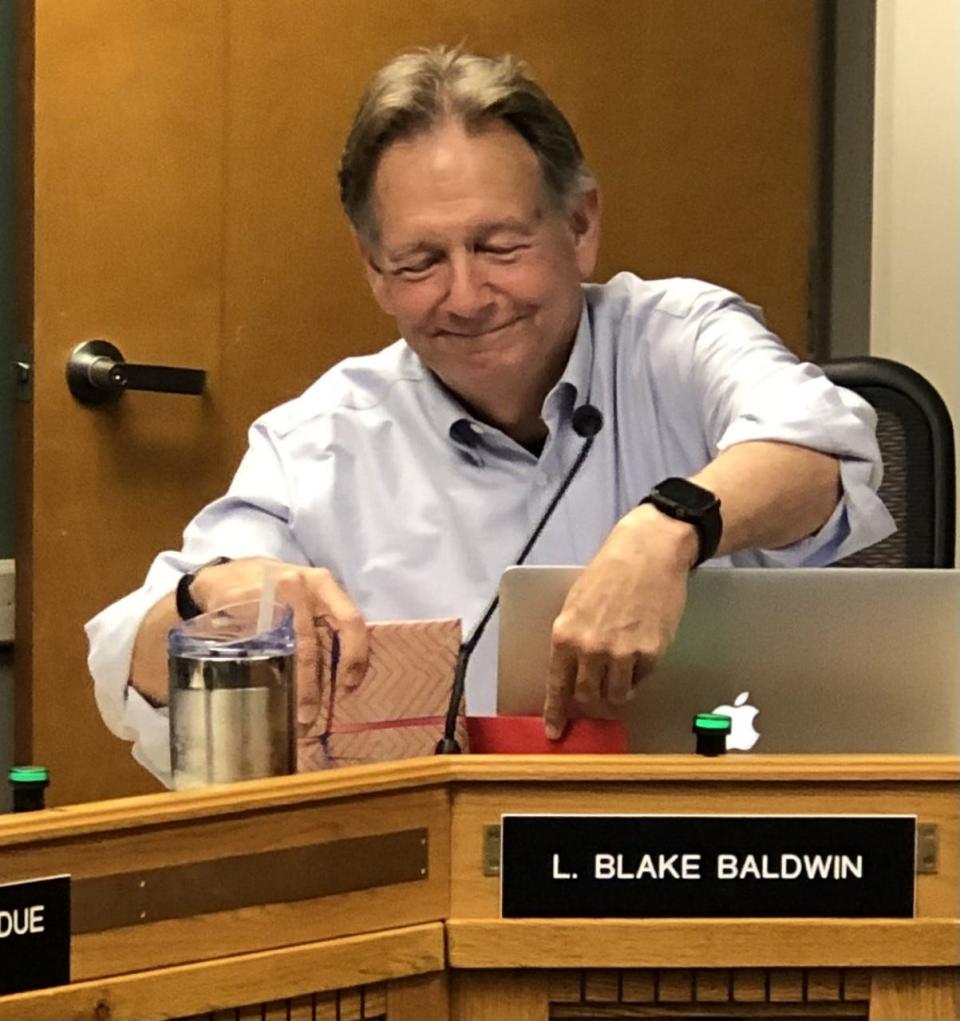 Kennebunk Select Board Chair Blake Baldwin sets down a gift presented to him during his final meeting as a selectperson on Tuesday, June 28, 2022.