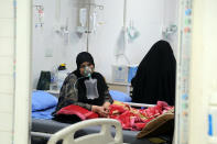 Coronavirus patients receive treatment at a hospital in Najaf, Iraq, Wednesday, July 14, 2021. Infections in Iraq have surged to record highs amid a third wave spurred by the more aggressive delta variant, and long-neglected hospitals suffering the effects of decades of war are overwhelmed with severely ill patients. (AP Photo/Anmar Khalil)