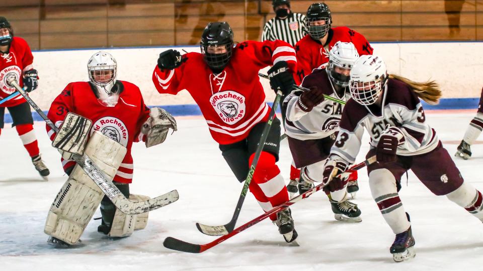 Amanda Wheeler of ORR and Adeline Youngclaus of Bishop Stang focus on a rebound off the pad of Megan Craig during a game on Monday. On Saturday, the Stang girls hockey team fell to Malden Catholic, 4-3.