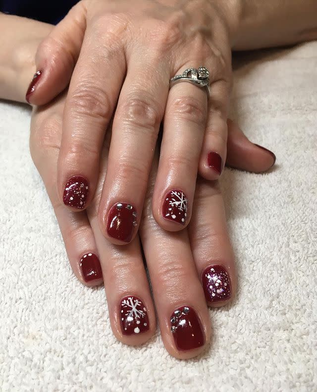 <p>Deep burgundies and clean, crisp whites are automatically gorgeous for the holidays. Get the blizzardy feel by layering on a clear, <a href="https://www.amazon.com/INM-Northern-Lights-Silver-Hologram/dp/B000PZA1MC/ref=sr_1_3?keywords=glitter+top+coat&qid=1575226579&s=beauty&sr=1-3&tag=syn-yahoo-20&ascsubtag=%5Bartid%7C10049.g.30065321%5Bsrc%7Cyahoo-us" rel="nofollow noopener" target="_blank" data-ylk="slk:glitter-dot top coat;elm:context_link;itc:0;sec:content-canvas" class="link ">glitter-dot top coat</a> over a few nails, alternating with hand-drawn snowflakes and rhinestones. ...Or maybe leave this one to your manicurist.</p><p><a href="https://www.instagram.com/p/B5gtlsShGAB/" rel="nofollow noopener" target="_blank" data-ylk="slk:See the original post on Instagram;elm:context_link;itc:0;sec:content-canvas" class="link ">See the original post on Instagram</a></p>