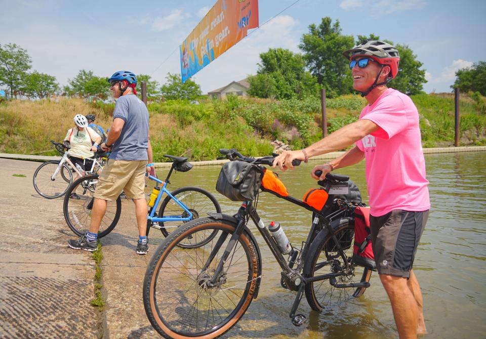 YouTube star Ryan Van Duzer dips his tire in the Missouri River to begin RAGBRAI 50 in Sioux City on Saturday.
