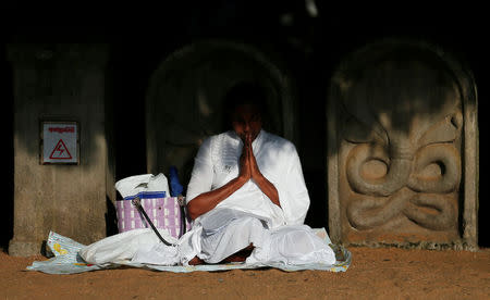 A Buddhist devotee worships at the Kelaniya Buddhist temple during Vesak Day, commemorating the birth, enlightenment and death of Buddha, in Colombo, Sri Lanka May 18, 2019. REUTERS/Dinuka Liyanawatte