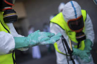 Spanish Royal Guard soldiers during disinfection work at a hospital to prevent the spread of the new coronavirus in Madrid, Spain, Sunday, March 29, 2020. Spain and Italy demanded more European help as they fight still-surging coronavirus infections amid the continent's worst crisis since World War II. The new coronavirus causes mild or moderate symptoms for most people, but for some, especially older adults and people with existing health problems, it can cause more severe illness or death. (AP Photo/Bernat Armangue)
