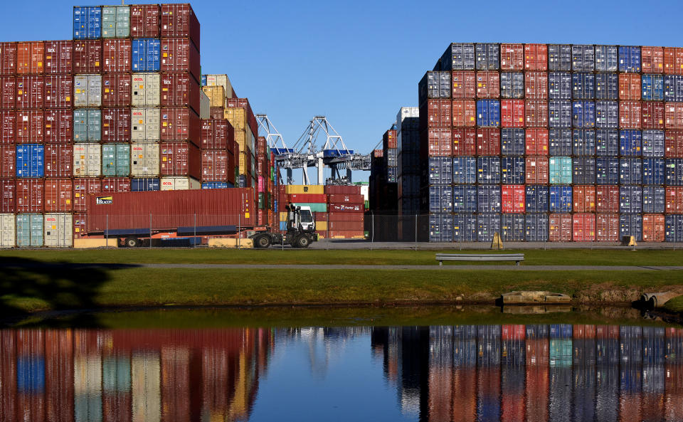 SAVANNAH, GEORGIA, UNITED STATES - 2021/10/23: A truck picks up a shipping container at the Port of Savannah in Georgia. 
The supply chain crisis has created a backlog of nearly 80,000 shipping containers at this port, the third-largest container port in the United States, with around 20 ships anchored off the Atlantic coast, waiting to offload their cargo. A shortage of truck drivers to transport goods from warehouses to retailers has caused shipping containers to be backed up at the port. (Photo by Paul Hennessy/SOPA Images/LightRocket via Getty Images)