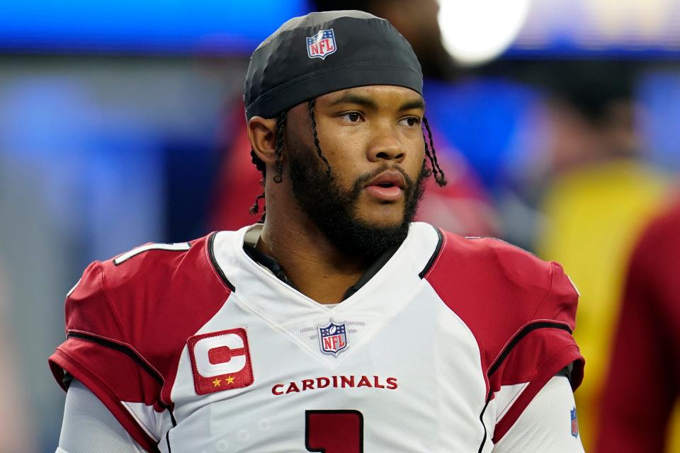 FILE - Arizona Cardinals quarterback Kyler Murray warms up before an NFL wild-card playoff football game against the Los Angeles Rams in Inglewood, Calif., Monday, Jan. 17, 2022. Kyler Murray has agreed to a long-term contract that will keep the quarterback with the Arizona Cardinals through the 2028 season. (AP Photo/Marcio Jose Sanchez, File)