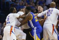 From left, Oklahoma City Thunder guard Semaj Christon (6) and guard Russell Westbrook, Golden State Warriors forward Draymond Green (23) and guard Klay Thompson, and Thunder forward Taj Gibson (22) get into a tussle during the second quarter of an NBA basketball game in Oklahoma City, Monday, March 20, 2017. (AP Photo/Sue Ogrocki)