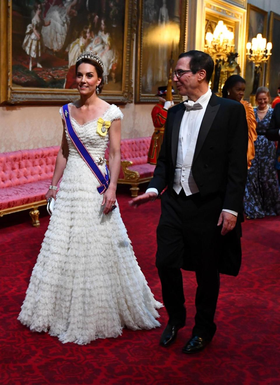 The Duchess of Cambridge and United States Secretary of the Treasury, Steven Mnuchin arrive through the East Gallery during the State Banquet at Buckingham Palace (PA)