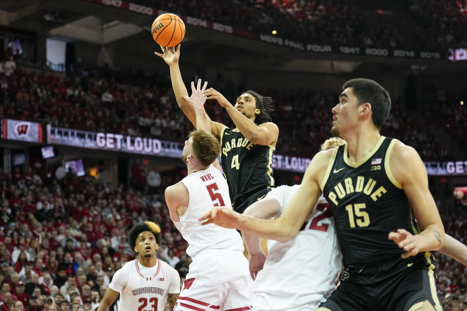 Purdue's Trey Kaufman-Renn (4) shoots against Wisconsin's Tyler Wahl (5) during the first half of an NCAA college basketball game Sunday, Feb. 4, 2024, in Madison, Wis. (AP Photo/Andy Manis)