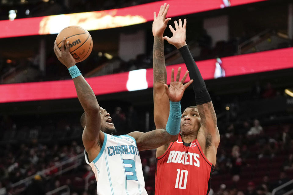 Charlotte Hornets guard Terry Rozier (3) shoots as Houston Rockets forward Jabari Smith Jr. defends during the second half of an NBA basketball game Wednesday, Nov. 1, 2023, in Houston. (AP Photo/Eric Christian Smith)
