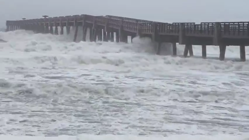 Big waves from Hurricane Ian battered the Jacksonville Beach pier at high tide Thursday, attacking the dunes.