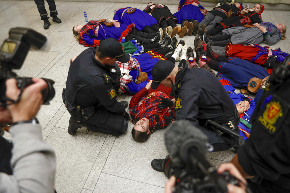 Demonstrators take part in a lie-in at the Norwegian Parliament in Oslo, Wednesday, Oct. 11 2023. Dozen of activists are protesting at Norway’s parliament to express frustration over the Norwegian government’s failure to shut down a wind farm they say endangers the way of life of Sami reindeer herders. The focus of Wednesday's demonstration was the 151 turbines of Europe’s largest onshore wind farm, which is located about 280 miles north of Oslo. (Frederik Ringnes/NTB via AP)