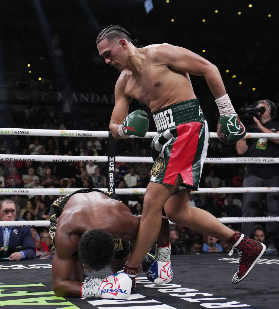 David Benavidez knocks down Demetrius Andrade during a super middleweight boxing match Saturday, Nov. 25, 2023, in Las Vegas. (AP Photo/John Locher)