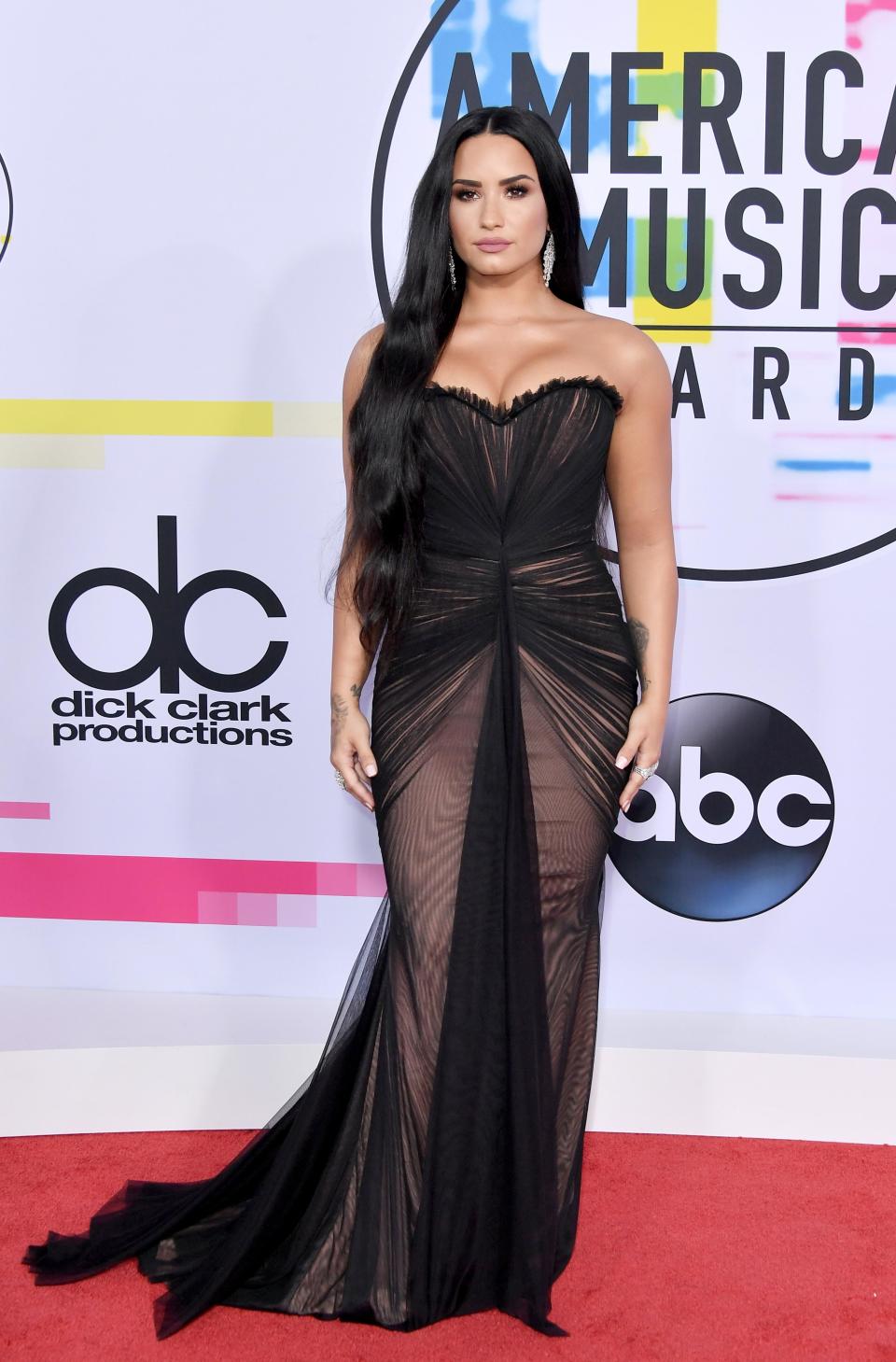 <p>Demi Lovato looked sultry in a strapless sheer black gown. The singer was definitely showing off her sexy side.</p>