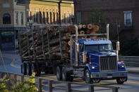 A log trucks rolls through Skowhegan, Maine, Tuesday, Sept. 14, 2021. The town that has relied on waterpower for its milling industries since the nineteenth century. (AP Photo/Robert F. Bukaty)