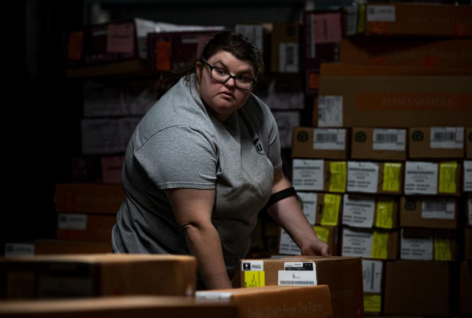 Katie King loaded packages onto a conveyor belt during a recent shift at the UPS Worldport facility in Louisville, Ky. King was hired on through the UPS Transitional Learning Center for people with physical or intellectual disabilities and is now working hard and earning her own money. Feb. 7, 2023
