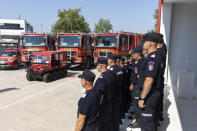 Romanian firefighters gather near to fire engines during a ceremony, in Athens, on Saturday, July 2, 2022. Twenty eight Romanian firefighters, the first of more than 200 firefighters from other European countries that will help their Greek colleagues in fighting wildfires, were welcomed by Climate Crisis and Civil Protection Minister Christos Stylianides and the leadership of Greece's Fire Service. (AP Photo/Yorgos Karahalis)