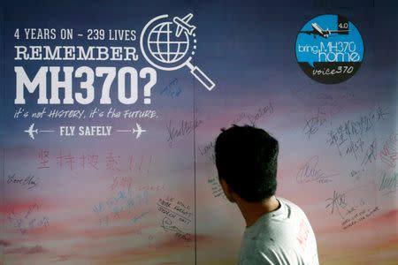 A man looks at a message board for passengers, onboard the missing Malaysia Airlines Flight MH370, during its fourth annual remembrance event in Kuala Lumpur, Malaysia March 3, 2018. REUTERS/Lai Seng Sin/Files