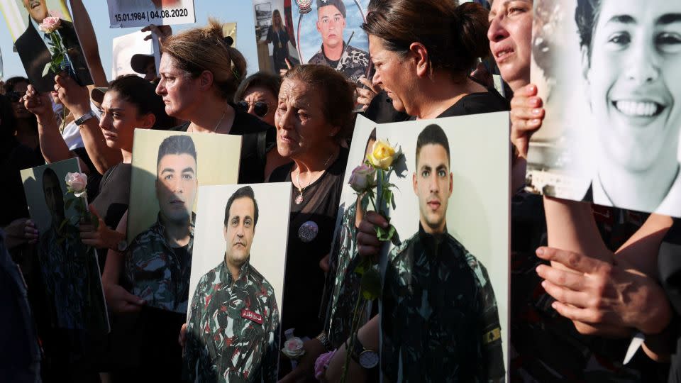 Relatives hold the pictures of some of those killed in the August 2020 Beirut port blast during a march marking the three-year anniversary of the disaster. - Emilie Madi/Reuters